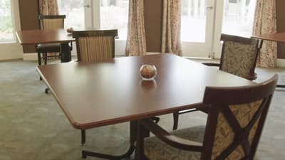 Common area with tables and chairs in a living space