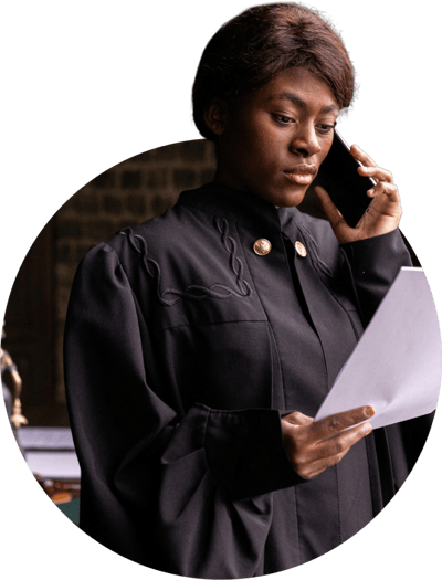 Woman in a judge's robe holding documents