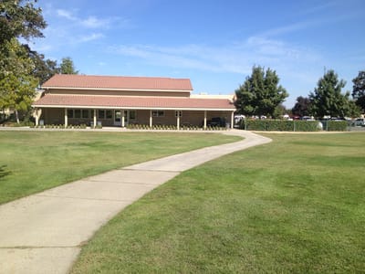 Main building exterior with pathway and lawn