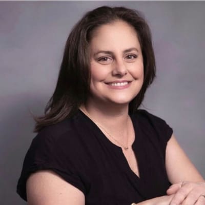 Smiling woman with long hair in a black top