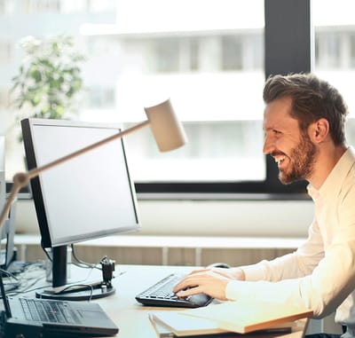 Man working at a desk in an office setting.