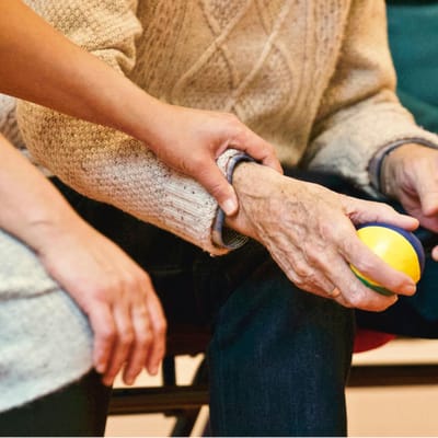 Close-up of a hand holding a stress ball.