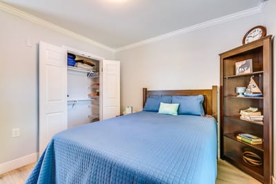 Cozy resident room with a bed and bookshelf