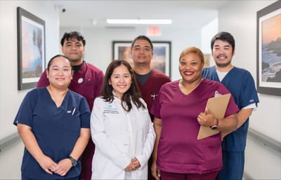 Staff members posing in a hallway at the facility