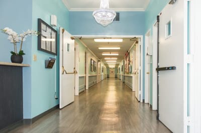 Interior corridor with a chandelier and blue walls