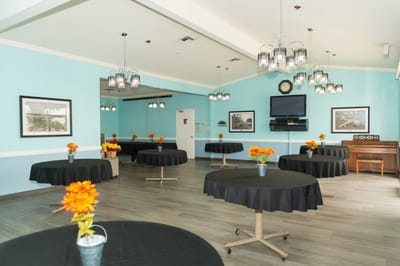An interior view of a common area with tables and flowers