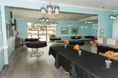 Bright common area with tables and flower arrangements
