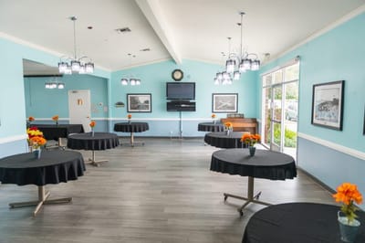 Modern common area with tables and floral centerpieces