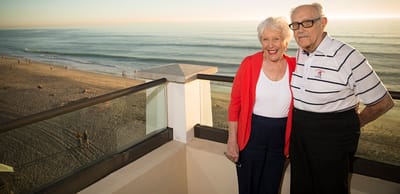 Couple enjoying a sunset view from a balcony