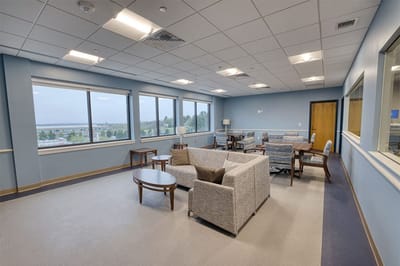 Bright common area with comfortable seating and large windows