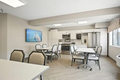 Common area with dining tables and kitchenette
