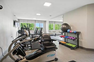 Fitness area with exercise equipment and large windows