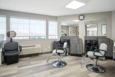 Salons chairs and mirrors in a hair salon area.