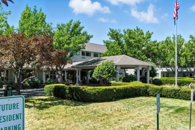 Exterior view of the assisted living facility with landscaping.