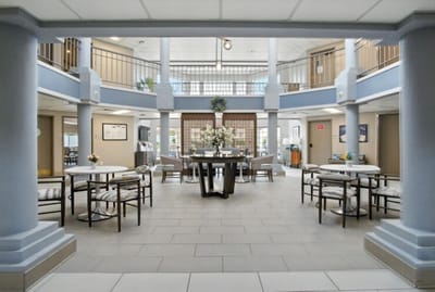Common area with tables and chairs in a facility.