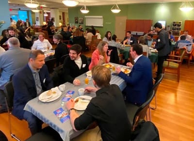 Residents and staff enjoying a meal together.