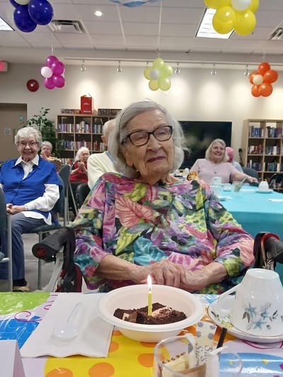 Resident celebrating with cake during an activity