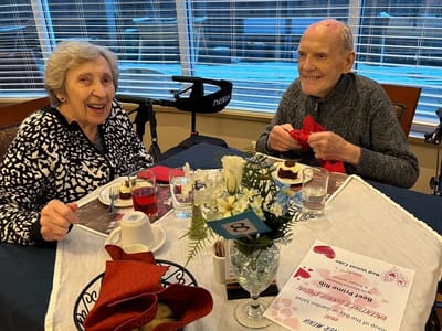 Residents enjoying dessert and conversation at a table