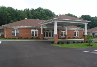 Facility front entrance with covered area and landscaping