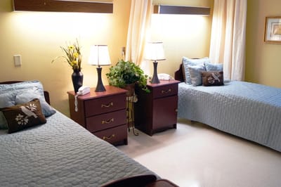 Cozy resident room with twin beds and lamps