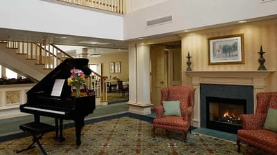 Cozy common area with a piano and fireplace