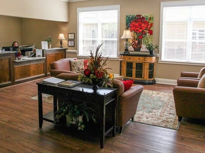 Bright interior common area with seating and flowers