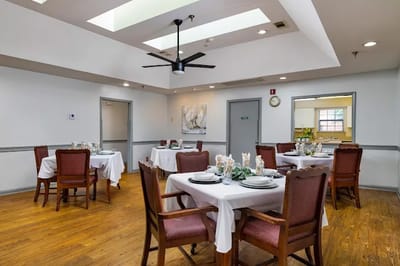 Bright dining room with tables set for a meal