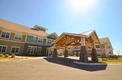 Exterior view of a nursing home building with entrance canopy
