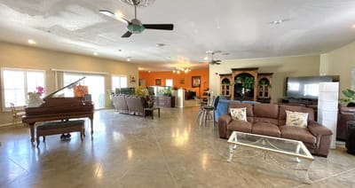 Bright common area with seating and a piano
