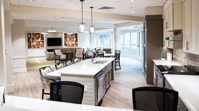 Bright common area with seating and a large window