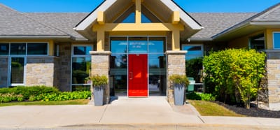 Front entrance of a senior living facility with landscaped surroundings