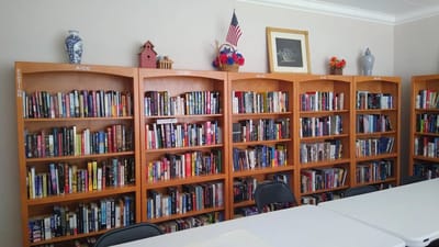 Bookshelves filled with a variety of books in a common area