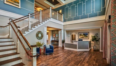Bright and welcoming reception area with a staircase