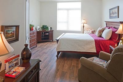 Cozy resident bedroom with soft lighting and furnishings
