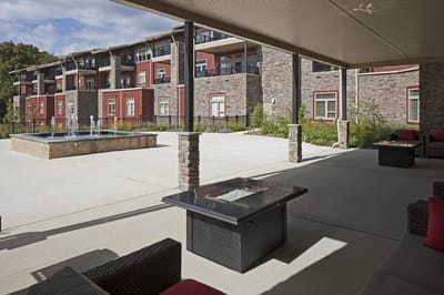 Outdoor patio area with seating and fountain