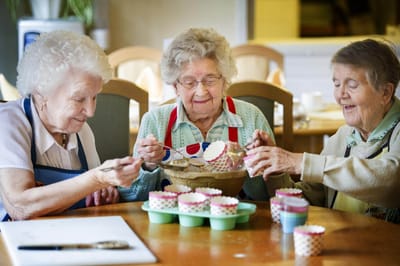 Residents baking cupcakes in a common area