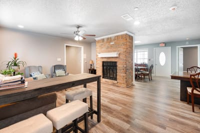 Bright common area with seating and dining space