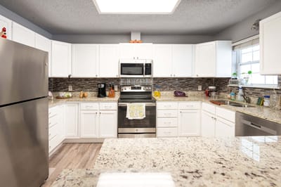 Modern kitchen with stainless steel appliances and white cabinets