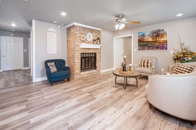 Bright common area with seating and a fireplace
