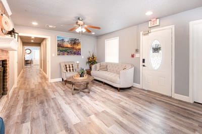 Bright common area with a sofa and artwork