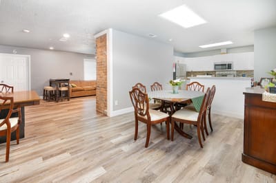 Interior view of a common area with dining tables and a sofa