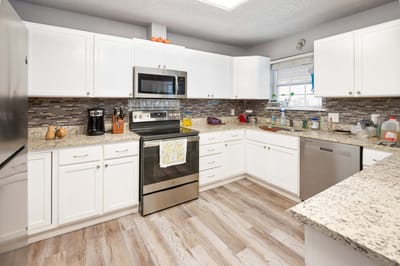Bright kitchen area with modern appliances and decor