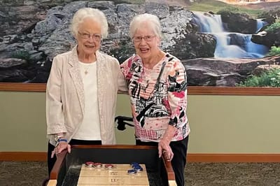 Two residents playing a game in the activity room