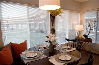 Dining table setup with a view of the garden outside