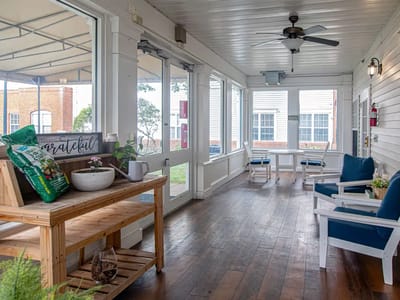 Bright sunroom with seating and décor