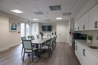 Bright common area with dining table and chairs
