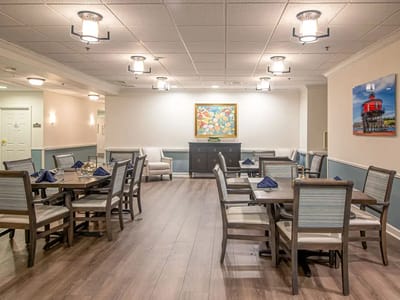 Bright dining room with tables and chairs set for a meal