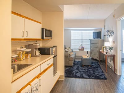 Well-furnished kitchen area leading to a cozy living room