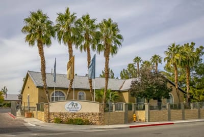 Exterior view of Villa Court Assisted Living with palm trees