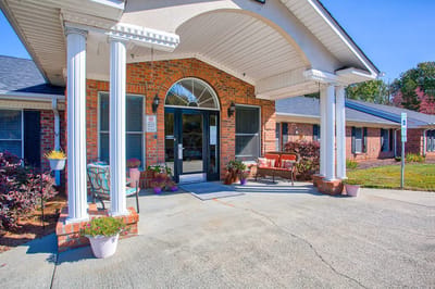 Entrance of Clemmons Village I with columns and seating area